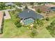 Aerial view of a gorgeous home with a screened pool, lush landscaping and well manicured lawn at 10002 Cherry Hills Avenue Cir, Bradenton, FL 34202