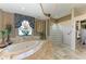 Bathroom boasts marble floors, a soaking tub, glass shower, and decorative tile accents at 10002 Cherry Hills Avenue Cir, Bradenton, FL 34202