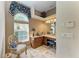 Bathroom vanity featuring a large mirror, wood cabinets, vanity seating, and a window offering natural light at 10002 Cherry Hills Avenue Cir, Bradenton, FL 34202
