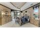 Spacious primary bedroom with elegant decor, decorative trim, and views of the landscaped yard at 10002 Cherry Hills Avenue Cir, Bradenton, FL 34202