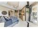 Luxurious bedroom with detailed trim, a decorative ceiling fan, and access to a private balcony at 10002 Cherry Hills Avenue Cir, Bradenton, FL 34202