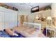 Bright bedroom with white decorative bed frame, closet, television and overhead fan at 10002 Cherry Hills Avenue Cir, Bradenton, FL 34202