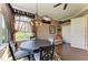 Dining area with breakfast table, chandelier, hardwood floors and tv at 10002 Cherry Hills Avenue Cir, Bradenton, FL 34202