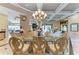 Elegant dining room with a glass table, ornate chairs, coffered ceiling, and views of the backyard at 10002 Cherry Hills Avenue Cir, Bradenton, FL 34202