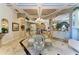 Formal dining room featuring chandelier, and elegant furnishings with adjacent views of the kitchen at 10002 Cherry Hills Avenue Cir, Bradenton, FL 34202