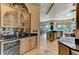 Spacious kitchen featuring black countertops, modern appliances, and adjacent view of the outdoor area at 10002 Cherry Hills Avenue Cir, Bradenton, FL 34202