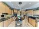 Well-lit kitchen features a large island, stainless appliances and custom wood cabinets at 10002 Cherry Hills Avenue Cir, Bradenton, FL 34202