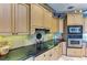 A kitchen with granite countertops, stainless steel appliances, and light brown cabinetry at 10002 Cherry Hills Avenue Cir, Bradenton, FL 34202