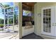 Outdoor kitchen with grill and shower adjacent to the screened-in pool area at 10002 Cherry Hills Avenue Cir, Bradenton, FL 34202