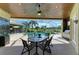 Covered lanai with outdoor dining area and view of screened-in pool at 10002 Cherry Hills Avenue Cir, Bradenton, FL 34202