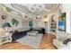 Well-decorated living room with hardwood floors, ceiling fan, and adjacent view of the backyard at 10002 Cherry Hills Avenue Cir, Bradenton, FL 34202