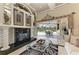 Living room with tile floors and sliding doors leading to the screened-in pool area at 10002 Cherry Hills Avenue Cir, Bradenton, FL 34202