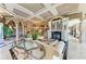 Spacious living room with a fireplace, coffered ceiling, marble floors, and stylish decor at 10002 Cherry Hills Avenue Cir, Bradenton, FL 34202
