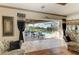 Living room with tile floors and sliding doors leading to the screened-in pool area at 10002 Cherry Hills Avenue Cir, Bradenton, FL 34202