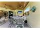 An outdoor bar with seating, a TV, and views of the living room and patio at 10002 Cherry Hills Avenue Cir, Bradenton, FL 34202