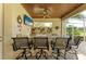 Stylish outdoor bar area, complete with bar seating, television, and scenic views, great for entertaining at 10002 Cherry Hills Avenue Cir, Bradenton, FL 34202