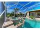 A luxurious screened-in pool and spa with water features and lush landscaping at 10002 Cherry Hills Avenue Cir, Bradenton, FL 34202