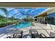 Relaxing screened-in pool and patio with lounge chairs and views of lush landscaping at 10002 Cherry Hills Avenue Cir, Bradenton, FL 34202