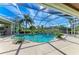 Inviting screened-in pool area with a waterfall feature and comfortable seating at 10002 Cherry Hills Avenue Cir, Bradenton, FL 34202