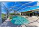 Inviting screened-in pool area with a waterfall feature and comfortable seating at 10002 Cherry Hills Avenue Cir, Bradenton, FL 34202