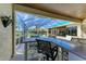 Outdoor living space with poolside bar, lush greenery, screened lanai, and golf course views at 10002 Cherry Hills Avenue Cir, Bradenton, FL 34202