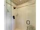 Modern bathroom shower with decorative tile work, updated fixtures, and glass door at 10002 Cherry Hills Avenue Cir, Bradenton, FL 34202