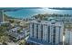 Scenic aerial view highlighting a modern condominium, waterfront, and lush landscape at 101 S Gulfstream Ave # 4J, Sarasota, FL 34236