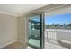 The sliding glass door gives access to the shaded rooftop balcony overlooking tropical landscaping at 101 S Gulfstream Ave # 4J, Sarasota, FL 34236