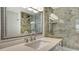 Close-up of the bathroom featuring a faucet with stylish vanity and a shower with patterned tile at 101 S Gulfstream Ave # 4J, Sarasota, FL 34236