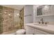 Bathroom featuring a tiled glass shower and a white vanity with toilet at 101 S Gulfstream Ave # 4J, Sarasota, FL 34236