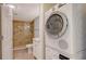 Bathroom with tiled shower next to the stackable washer and dryer unit at 101 S Gulfstream Ave # 4J, Sarasota, FL 34236