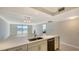 Modern kitchen with stainless steel appliances, neutral cabinets and fixtures, and an island with stone countertop at 101 S Gulfstream Ave # 4J, Sarasota, FL 34236