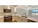 Modern kitchen featuring stainless steel appliances, sleek countertops, and contemporary fixtures and stylish backsplash at 101 S Gulfstream Ave # 4J, Sarasota, FL 34236