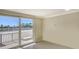 Bright living room featuring tile floors, a sliding glass door to the large balcony with a view at 101 S Gulfstream Ave # 4J, Sarasota, FL 34236