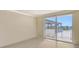 Bright living room featuring tile floors, a sliding glass door to a shaded rooftop balcony at 101 S Gulfstream Ave # 4J, Sarasota, FL 34236