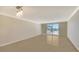 Bright living room featuring tile floors, a sliding glass door to the balcony and modern lighting fixture at 101 S Gulfstream Ave # 4J, Sarasota, FL 34236