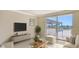 Virtual staging showing the living room with access to the shaded rooftop balcony at 101 S Gulfstream Ave # 4J, Sarasota, FL 34236