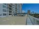 Condo building featuring a spacious pool deck and a partial view of the downtown skyline at 101 S Gulfstream Ave # 4J, Sarasota, FL 34236