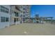 Condo building featuring a spacious pool deck and a partial view of the downtown skyline at 101 S Gulfstream Ave # 4J, Sarasota, FL 34236