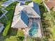 Aerial view showing home, lush landscaping, and a screened-in pool enclosure at 10306 Palmbrooke Ter, Bradenton, FL 34202