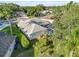 Aerial view capturing home featuring a screened-in pool enclosure and mature landscaping at 10306 Palmbrooke Ter, Bradenton, FL 34202