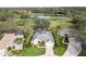 Scenic aerial view of a home with a well-kept lawn, mature trees, and a serene pond nearby at 10306 Palmbrooke Ter, Bradenton, FL 34202