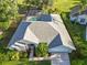 Aerial view of a well-maintained home with a screened-in pool and a meticulously landscaped yard at 10306 Palmbrooke Ter, Bradenton, FL 34202