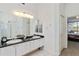 Bright bathroom features double sinks, dark granite countertops, and a large mirror at 10306 Palmbrooke Ter, Bradenton, FL 34202