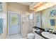 Bathroom with a glass-enclosed shower and walk-out access to the backyard pool at 10306 Palmbrooke Ter, Bradenton, FL 34202