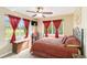 Bedroom showcasing warm-toned decor, a decorative bed, and large bright windows at 10306 Palmbrooke Ter, Bradenton, FL 34202