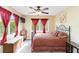 Bedroom showcasing warm-toned decor, a decorative bed, and large bright windows at 10306 Palmbrooke Ter, Bradenton, FL 34202