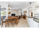Open-concept kitchen and dining area with tile floors, bar seating, and outdoor view at 10306 Palmbrooke Ter, Bradenton, FL 34202