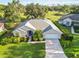 Beautifully landscaped home with a well-manicured lawn, mature trees, and an attached two-car garage at 10306 Palmbrooke Ter, Bradenton, FL 34202