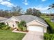 Beautifully maintained home with lush landscaping, attached two-car garage, and mature trees at 10306 Palmbrooke Ter, Bradenton, FL 34202